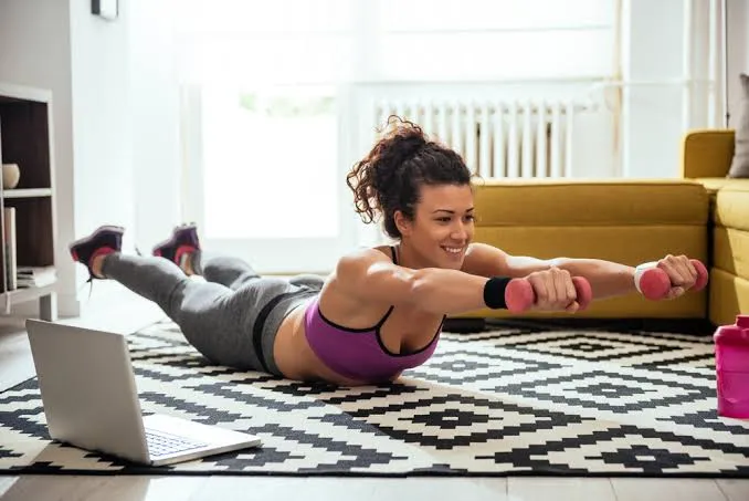 Person doing a plank exercise on a clean floor surface